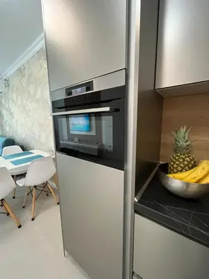 a kitchen with a refrigerator and a bowl of pineapple at Luxury Private Apartment near Green Life Resort in Sozopol