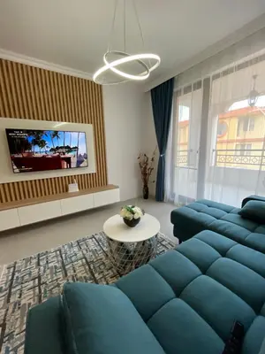 a living room with a blue couch and a table at Luxury Private Apartment near Green Life Resort in Sozopol