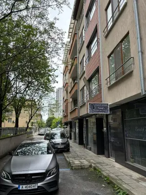 two cars parked on a street next to a building at Студио Бургас 2 in Burgas City