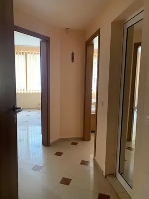 a hallway with two doors and a tile floor at Студио Бургас 2 in Burgas City