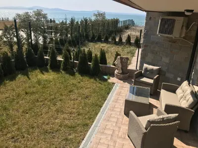 a patio with chairs and a view of a yard at Sunrise Beach A4, Sarafovo in Burgas City