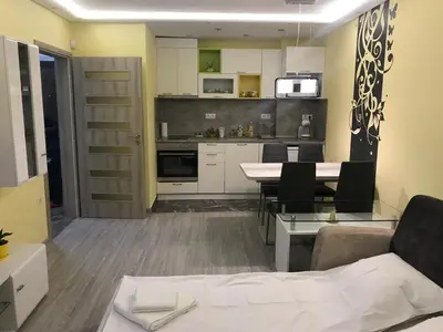 a kitchen and living room with a table and chairs at Sunrise Beach A4, Sarafovo in Burgas City