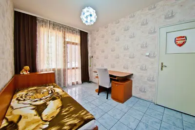 a hotel room with a bed and a desk and a desk at Perla 2-bdrm in the heart of the city in Varna City