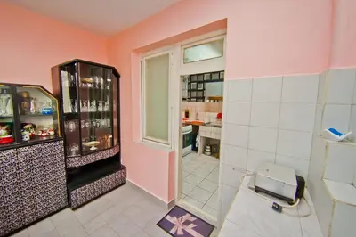 a pink room with a refrigerator and a window at Perla 2-bdrm in the heart of the city in Varna City