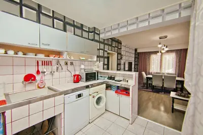 a kitchen with a washing machine and a dining room at Perla 2-bdrm in the heart of the city in Varna City