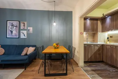 a living room with a table and a blue couch at SeaBed Haven in Varna City