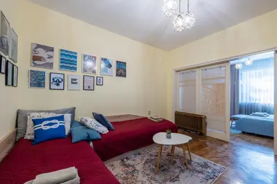a bedroom with a red bed and a table at SeaBed Haven in Varna City