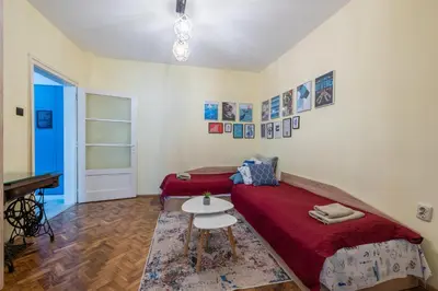 a room with two beds and a table in it at SeaBed Haven in Varna City
