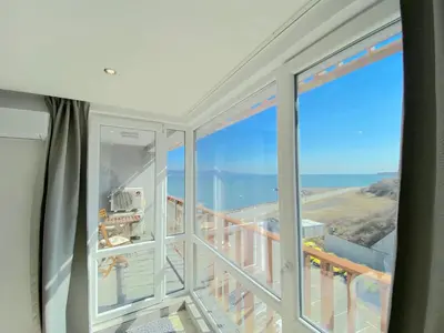 a room with a balcony with a view of the ocean at Paradiso Aparthotel - Private apartment -BSR-2 in Nesebar