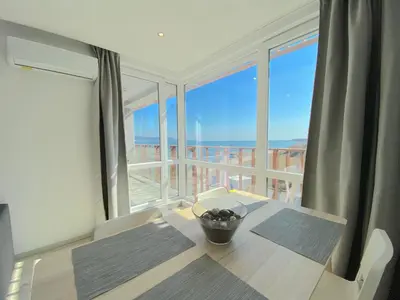 a dining room table with a view of the ocean at Paradiso Aparthotel - Private apartment -BSR-2 in Nesebar