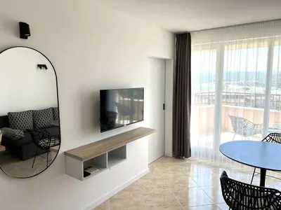 a living room with a television and a table at Villa Mia in Sozopol