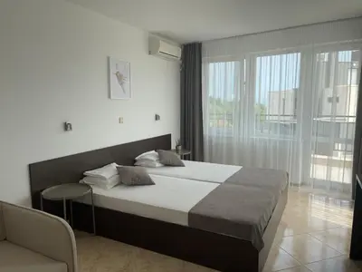 a bedroom with a large bed and a window at Villa Mia in Sozopol