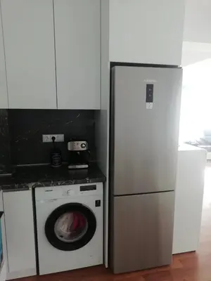 a kitchen with a washing machine and a refrigerator at Sun Gates Byala in Byala