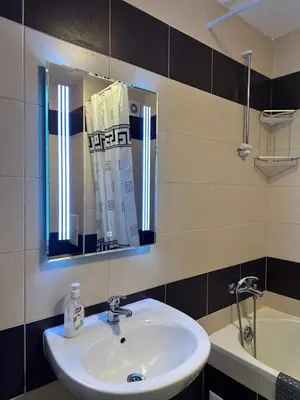a bathroom with a sink and a mirror and a tub at Sun Gates Byala in Byala