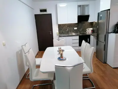 a kitchen with a white table and white chairs at Sun Gates Byala in Byala