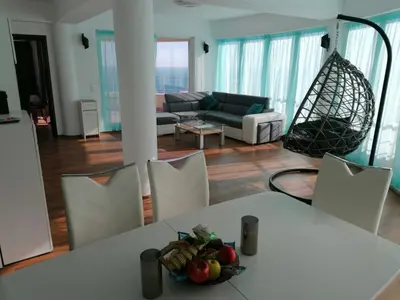 a living room with a table with a bowl of fruit on it at Sun Gates Byala in Byala