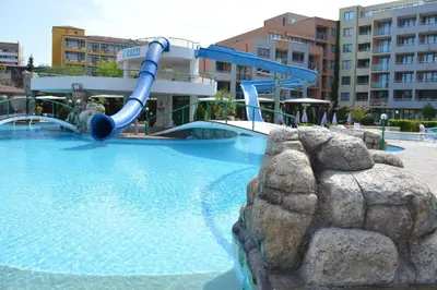 a water slide in a swimming pool in a resort at Trakia Plaza Apartment in Sunny Beach