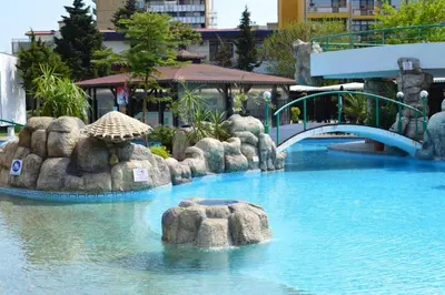 a water slide in a resort with a bridge at Trakia Plaza Apartment in Sunny Beach
