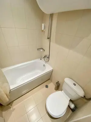 a bathroom with a toilet and a bath tub and a toilet at Trakia Plaza Apartment in Sunny Beach