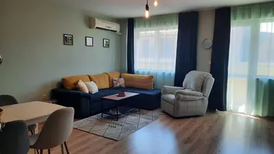 a living room with a couch and a chair at Soulful Apartments - AlmaLetta in Varna City