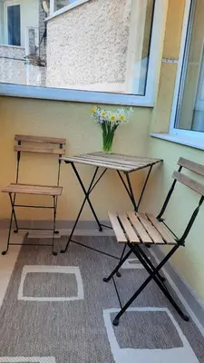 a table and a bench and a vase of flowers at Soulful Apartments - AlmaLetta in Varna City