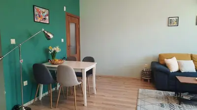 a living room with a table and a couch at Soulful Apartments - AlmaLetta in Varna City