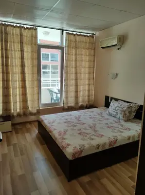 a bedroom with a bed and a window at Dunav-Lazur Apt.5 in Ravda