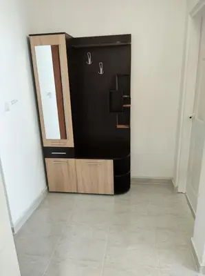 a black and wooden refrigerator in a room at Dunav-Lazur Apt.5 in Ravda