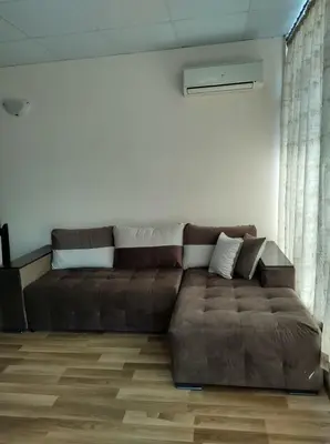 a brown leather couch in a living room at Dunav-Lazur Apt.5 in Ravda