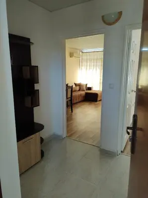 a living room with a couch and a room with a mirror at Dunav-Lazur Apt.5 in Ravda