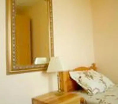 a bedroom with a mirror and a lamp on a table at Welcoming house in Varna with sea view in Varna City
