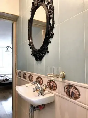 a bathroom with a sink and a mirror on the wall at Welcoming house in Varna with sea view in Varna City