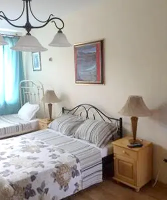 a bedroom with two beds and two lamps in it at Welcoming house in Varna with sea view in Varna City