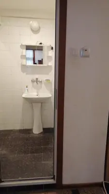 a bathroom with a sink and a mirror at 27 юли 3 бюджет in Varna City