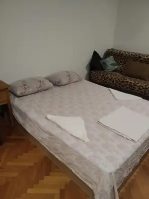 a bed with two napkins on it in a room at 27 юли 3 бюджет in Varna City
