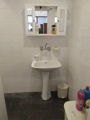 a bathroom with a white sink and a mirror at 27 юли 3 бюджет in Varna City