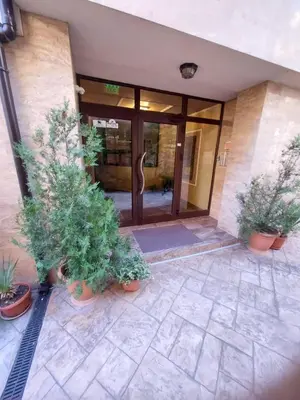 an entrance to a building with potted plants in front at Студио Прованс Лариса in Pomorie