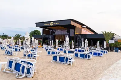 a bunch of chairs and umbrellas on a beach at Menada Casa del Sol Apartments in Sunny Beach