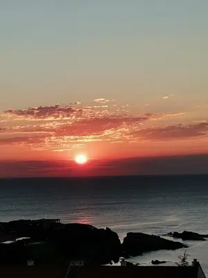 a sunset over the ocean with the sun in the sky at Sunrise place Eva in Sozopol