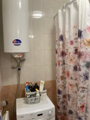 a bathroom with a shower curtain and a cabinet at Art studio Marina Cape-private host in Ravda