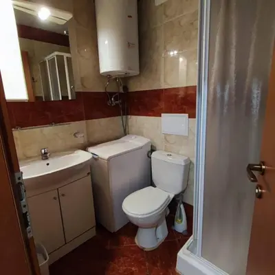 a small bathroom with a toilet and a sink at Apartament with See View in Sveti Vlas