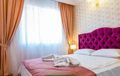 a bedroom with a large bed with a purple headboard at Sweet Homes 6 in Sunny Beach