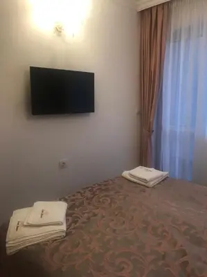 a bedroom with a bed with a flat screen tv on the wall at Sweet Homes 6 in Sunny Beach