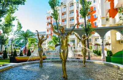 a fountain with three girls in the water in a city at Sweet Homes 6 in Sunny Beach