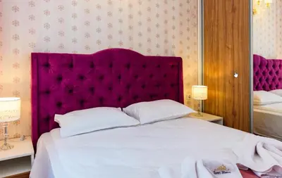 a bedroom with a large bed with a purple headboard at Sweet Homes 6 in Sunny Beach