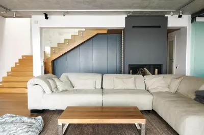 a living room with a white couch and a table at Beach Villa Varna - cosiness 4 meters from the sea in Varna City