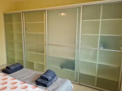 a bathroom with a shower and two towels on a bed at Spacious apartment 