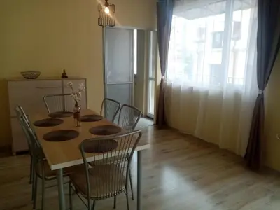 a dining room with a table with chairs and a window at Spacious apartment 