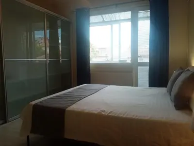 a bedroom with a large bed with a large window at Spacious apartment 