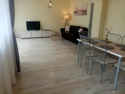 a living room with a table and chairs and a couch at Spacious apartment 